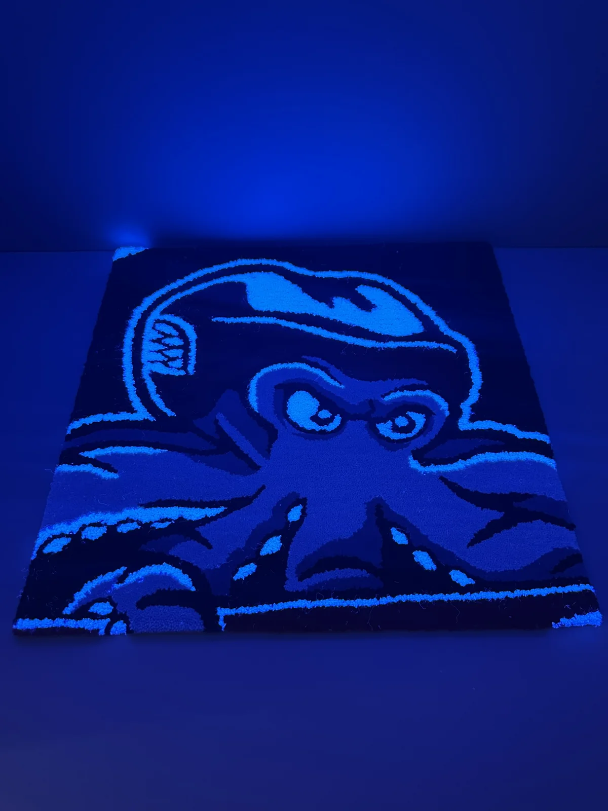 Detroit octopus rug glowing under UV light